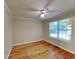 Bright bedroom with hardwood floors and a large window at 4230 Pilgrim Point Rd, Cumming, GA 30041