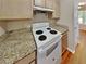 Kitchen with granite countertops and white appliances at 4230 Pilgrim Point Rd, Cumming, GA 30041