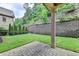 Private backyard with grassy area and paver patio at 7890 Royal Melbourne Way, Duluth, GA 30097