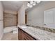 Bathroom with granite countertop, dark wood cabinets, and shower/tub combo at 7890 Royal Melbourne Way, Duluth, GA 30097