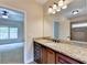 Bathroom with granite countertop, dark wood cabinets, and an updated vanity at 7890 Royal Melbourne Way, Duluth, GA 30097