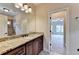 Bathroom with granite countertop, dark wood cabinets, and an updated vanity at 7890 Royal Melbourne Way, Duluth, GA 30097