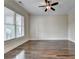 Bright bedroom with hardwood floors and ceiling fan at 7890 Royal Melbourne Way, Duluth, GA 30097