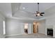 Main bedroom with ensuite bathroom access and fireplace at 7890 Royal Melbourne Way, Duluth, GA 30097