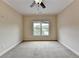 Spacious bedroom with neutral carpeting and large windows at 7890 Royal Melbourne Way, Duluth, GA 30097