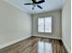 Bright bedroom with hardwood floors and ceiling fan at 7890 Royal Melbourne Way, Duluth, GA 30097