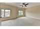 Bright bedroom with neutral walls, carpeting, and two large windows at 7890 Royal Melbourne Way, Duluth, GA 30097