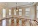 Bright dining room with hardwood floors, wainscoting, and a stunning chandelier at 7890 Royal Melbourne Way, Duluth, GA 30097