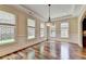 Spacious dining room with hardwood floors and multiple windows at 7890 Royal Melbourne Way, Duluth, GA 30097