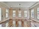 Formal dining room features hardwood floors, wainscoting, and lots of natural light at 7890 Royal Melbourne Way, Duluth, GA 30097