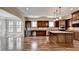 Gourmet kitchen with granite counters and dark wood cabinets at 7890 Royal Melbourne Way, Duluth, GA 30097