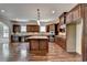 Gourmet kitchen with granite counters and dark wood cabinets at 7890 Royal Melbourne Way, Duluth, GA 30097