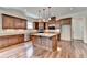 Gourmet kitchen with island, stainless steel appliances, granite countertops, and hardwood floors at 7890 Royal Melbourne Way, Duluth, GA 30097