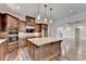 Eat-in kitchen features double ovens, granite counters, and an abundance of cabinetry at 7890 Royal Melbourne Way, Duluth, GA 30097