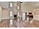 High-ceilinged living room with hardwood floors and fireplace at 7890 Royal Melbourne Way, Duluth, GA 30097