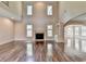 Two-story living room with hardwood floors and a fireplace at 7890 Royal Melbourne Way, Duluth, GA 30097