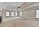 Main bedroom with tray ceiling, fireplace, and neutral carpet at 7890 Royal Melbourne Way, Duluth, GA 30097