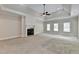 Main bedroom with tray ceiling, fireplace, and neutral carpet at 7890 Royal Melbourne Way, Duluth, GA 30097