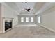 Main bedroom with tray ceiling, fireplace, and neutral carpet at 7890 Royal Melbourne Way, Duluth, GA 30097