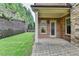 Brick patio adjacent to the house and grassy backyard at 7890 Royal Melbourne Way, Duluth, GA 30097