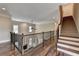 Upstairs hallway with hardwood floors and iron railing at 7890 Royal Melbourne Way, Duluth, GA 30097