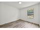 Bright and airy bedroom with large window and wood-look floors at 1669 Liberty Vly, Decatur, GA 30032