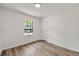 Simple bedroom with large window and wood-look floors at 1669 Liberty Vly, Decatur, GA 30032