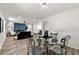 Bright dining area with glass table and four chairs, adjacent to living space at 1669 Liberty Vly, Decatur, GA 30032