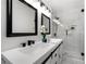 Modern bathroom featuring double sinks, matte black fixtures, a glass shower enclosure and natural light at 2277 Cloverdale Se Dr, Atlanta, GA 30316