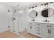 An open bathroom featuring double sinks, marble countertops, and an open glass shower at 2277 Cloverdale Se Dr, Atlanta, GA 30316