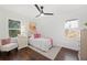 Bright bedroom with chair, light walls, neutral carpet, and vibrant pink accents at 2277 Cloverdale Se Dr, Atlanta, GA 30316