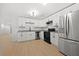 Modern white kitchen featuring stainless steel appliances, granite countertops, and an island at 2277 Cloverdale Se Dr, Atlanta, GA 30316