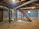 Spacious unfinished basement featuring wooden stairs and HVAC systems at 6242 Prestley Mill Rd, Douglasville, GA 30134