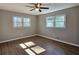 Hardwood floor bedroom with ceiling fan and multiple windows at 6242 Prestley Mill Rd, Douglasville, GA 30134