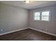 Simple bedroom with hardwood floors and neutral walls at 6242 Prestley Mill Rd, Douglasville, GA 30134