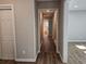 Bright hallway with hardwood floors leading to bedrooms and bath at 6242 Prestley Mill Rd, Douglasville, GA 30134