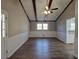 Spacious living room with hardwood floors and wood beams at 6242 Prestley Mill Rd, Douglasville, GA 30134