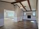 Living room with wood beams, a fireplace, and hardwood floors at 6242 Prestley Mill Rd, Douglasville, GA 30134