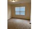 Carpeted bedroom with natural light, window, and neutral walls, creating a cozy atmosphere at 7981 Gossamer Dr, Fairburn, GA 30213