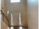 Light-filled foyer with high ceilings, hardwood floors, and a view of the staircase at 7981 Gossamer Dr, Fairburn, GA 30213