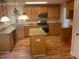 Well-lit kitchen features stainless appliances, granite countertops, and central island at 7981 Gossamer Dr, Fairburn, GA 30213