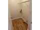 Compact laundry room with wood-look flooring and wire shelving above at 7981 Gossamer Dr, Fairburn, GA 30213