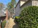 Side yard featuring mature trees and shrubs, offering privacy and natural beauty at 7981 Gossamer Dr, Fairburn, GA 30213