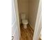 Powder room featuring wood-look floors and neutral walls, providing a convenient and stylish space at 7981 Gossamer Dr, Fairburn, GA 30213