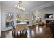 Dining room featuring hardwood floors, large windows, and a fireplace in the adjacent living room at 1479 Brentwood Dr, Marietta, GA 30062