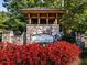 Stone entrance to the Great Sky community with red flowers in the foreground at 2012 Ripple Park Bnd, Canton, GA 30114