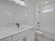 Modern bathroom featuring sleek vanity, large mirror, and a combination tub and shower with white tile at 2012 Ripple Park Bnd, Canton, GA 30114