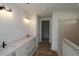 Bathroom with double vanity and large tiled shower and overhead lights at 2012 Ripple Park Bnd, Canton, GA 30114