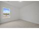 Neutral carpeted bedroom with a window that offers a view of the outdoors at 2012 Ripple Park Bnd, Canton, GA 30114