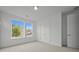 Bright bedroom with neutral carpet, white walls, large windows, closet, and a white door at 2012 Ripple Park Bnd, Canton, GA 30114